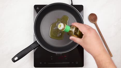 Olive-oil-in-the-hot-pan-in-the-top-view