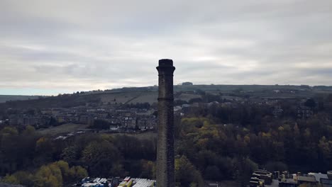 Factory-cooling-tower-in-the-Industrial-town,-village-in-the-heart-of-the-Yorkshire-Pennines-Hills
