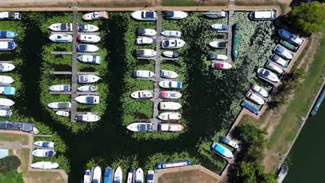 Vertical-aerial-view-of-a-marina-full-of-boats-and-barges