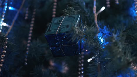 celebrating-holiday-with-blue-LED-Christmas-tree-with-present-decorations-in-4k-resolution