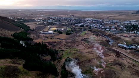 Aerial-View-Over-Hot-Springs-Towards-Town-Of-Hveragerdi-In-South-Iceland---drone-shot