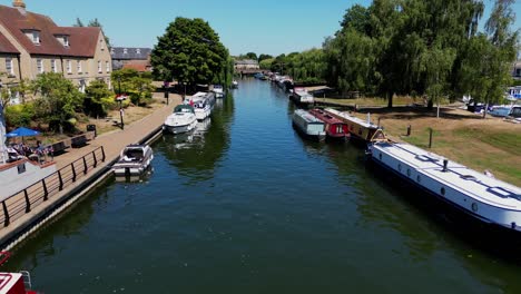 Aerial-view-of-the-River-Great-Ouse-at-Ely,-with-boats-and-barges-on-a-summer-day
