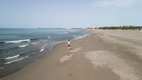 Man-sprinting-on-the-beach-alone