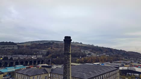 Factory-cooling-tower-in-the-Industrial-town,-village-in-the-heart-of-the-West-Yorkshire-Pennines-Hills