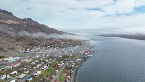 Faskrudsfjordur-Town-On-A-Cloudy-Day-In-East-Iceland---aerial-drone-shot