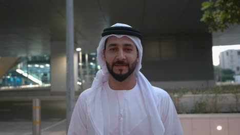 Walking-Emirati-UAE-national-wearing-cultural-Kandura-and-Ghutra-men's-wear-common-in-Gulf-and-Middle-East-countries