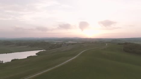 A-drone-shot-of-a-sunset-over-the-rolling-hills-of-Tuscany