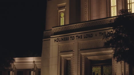 Inscription-above-LDS-Church-Mormon-Temple-Front-Doors-that-says-"Holiness-to-the-Lord,-The-House-of-the-Lord"-at-Night-in-Gilbert,-Arizona