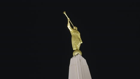 Golden-Statue-of-the-Angel-Moroni-with-Trumpet-in-Hand-on-top-of-LDS-Church-Mormon-Temple-at-Night-in-Gilbert,-Arizona