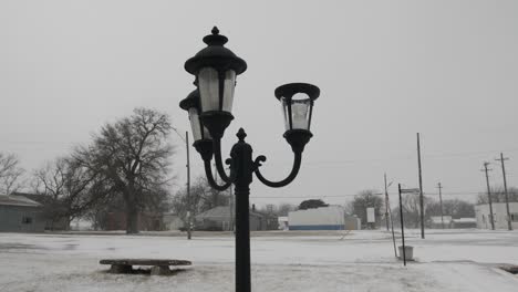 Vintage-looking-light-post-and-bulbs-in-a-quiet-park-in-a-small,-midwest-town-in-Kansas-on-a-cold-winter-day-in-December-during-Christmas-time