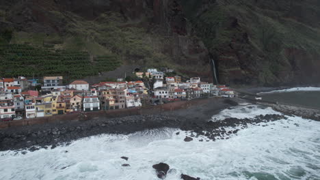 Aerial-shot-over-the-city-of-Paul-do-Mar-and-where-you-can-see-the-beautiful-waterfall-and-the-houses-on-the-coast