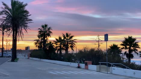 Beautiful-sunrise-over-the-Saint-Julian-fort-with-traffic-on-a-main-road-in-Carcavelos