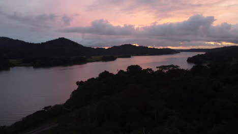 Cinematic-late-evening-view-of-the-Panama-Canal-and-its-surrounding-jungle-of-Gamboa-with-lovely-colors-in-the-sky-around-twilight