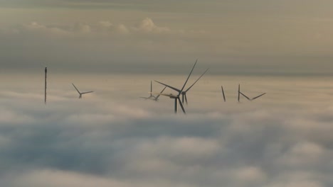 Aerial-Drone-Shot-of-Wind-Turbines-Above-The-Clouds