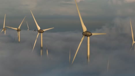 Aerial-Drone-Shot-Flying-Over-Wind-Farm-Above-the-Clouds-and-Mist