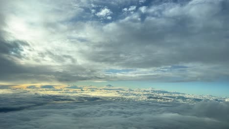 Pilot-point-of-view-of-a-cold-winter-cloudy-sky-at-sunset-during-cruise-level