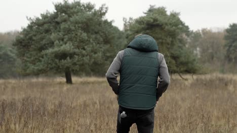 Man-walking-into-the-forest-and-feels-his-pockets-because-he-thinks-he-forgot-something