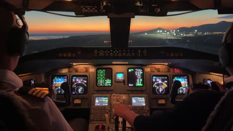 Jet-cockpit-view-during-a-real-landing-to-Ibiza’s-airport,-Spain,-during-sunset