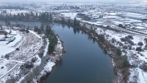 Vista-Aérea-De-Una-Curva-En-El-Río-Spokane-Durante-Los-Meses-De-Invierno-Con-Nieve-Que-Lo-Rodea