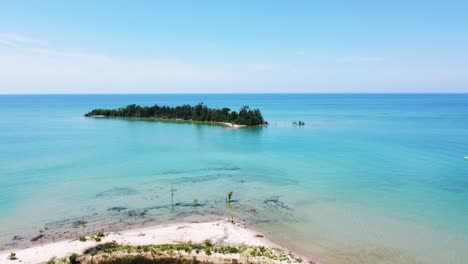 Blue-Water-Aerial-of-Beach-and-Island---Fisherman-Island,-Michigan