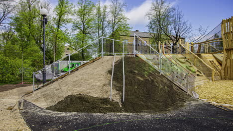 Timelapse-shot-of-workers-cementing-the-slope-of-an-elevated-play-house-for-kids-in-playground-in-a-park-at-daytime