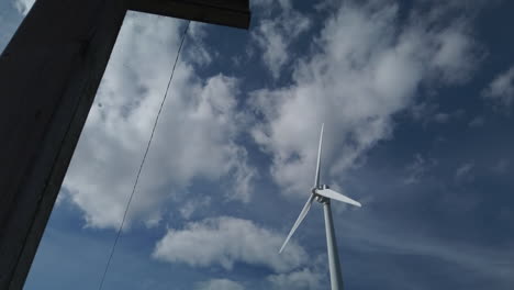 Exterior-low-angle-shot-of-a-moving-wind-turbine