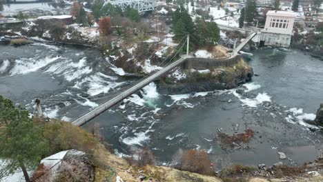 Aerial-view-of-a-pedestrian-bridge-that-connects-downtown-Spokane-to-Canada-Island-in-Riverfront-Park