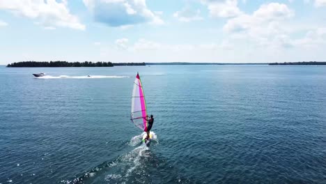 Windsurfer-Catching-Wind---Aerial-Follow---Lake-Huron---Hessel,-Michigan