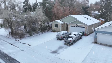 Exterior-aerial-view-of-a-snowed-in-home-during-a-winter-snow-storm