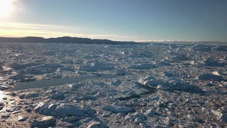 Aerial-view-of-the-impressive-ice-fiord-surrounding-Ilulissat,-Greenland