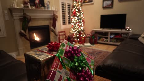 Christmas-gifts-with-the-Christmas-tree-in-the-background-with-a-cozy-fireplace---sliding-tilt-up-reveal
