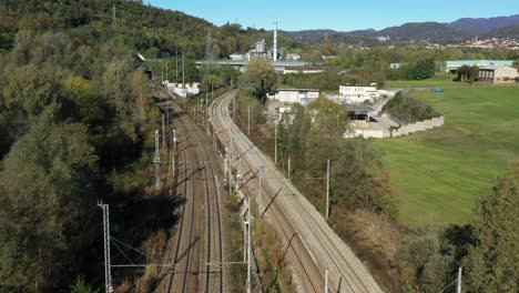 Drone-view-of-the-railroad-junction-at-the-Monte-Olimpino-2-tunnel-in-the-province-of-Como,-Italy,-which-connects-freight-traffic-between-Chiasso-in-Switzerland-and-Milan-in-Italy