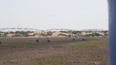 Pan-Left-Reveal-View-Of-Center-Pivot-Irrigation-Sprinkler-System-On-Farmland-In-Punjab