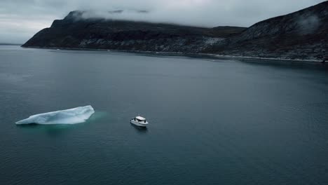 Aerial-of-a-motorboat-in-ice-water-by-a-giant-icecap