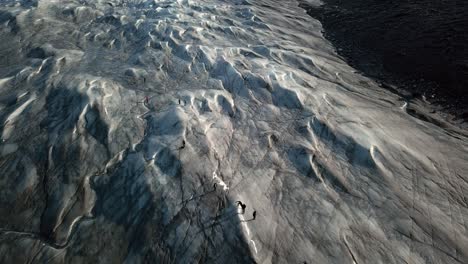Aerial-view-over-peoplewalking-the-icecap-at-pinot-660,-just-outside-Kangerlussuaq,-Greenland