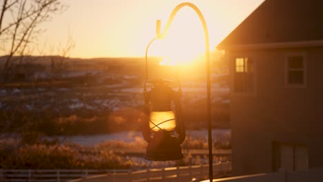 The-golden-glow-of-the-setting-sun-with-a-vintage-lantern-lighting-the-foreground---parallax-sliding-motion