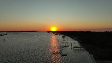 Aerial-view-of-sunset-over-inlet-waterway-near-Wolf-Bay
