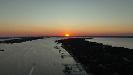Aerial-reverse-view-of-sunset-over-Alabama-near-inlet-waterway-and-Wolf-Bay