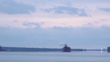 Static-shot-of-freighter-going-up-a-calm-river-on-a-cloudy-day