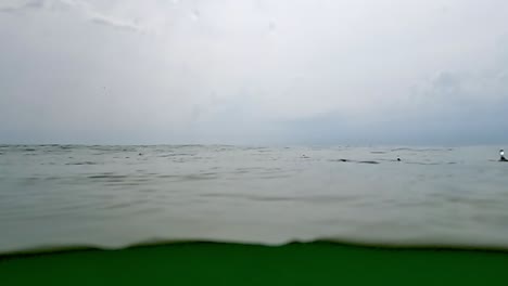 Raindrops-on-sea-surface-and-horizon-in-background