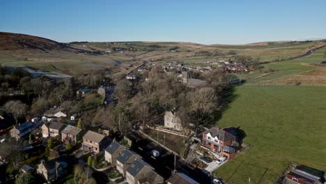 Aerial-footage-of-the-quite-village-of-Denshaw,-and-the-church-and-graveyard,-a-typical-rural-village-in-the-heart-of-the-Pennines