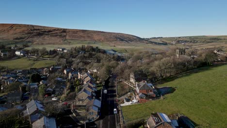 Aerial-footage-of-the-village-of-Denshaw,-and-the-church-and-graveyard,-a-typical-rural-village-in-the-heart-of-the-Pennines