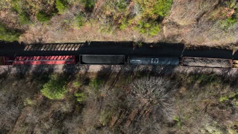 Top-down-aerial-of-train-car-carrying-coal-on-track