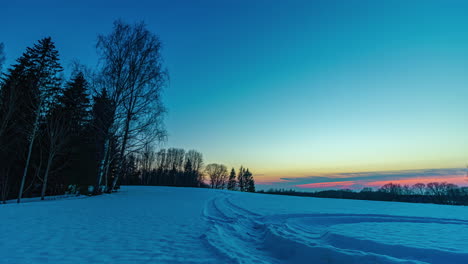 Golden-Orange-Sun-Setting-On-Horizon-Over-Winter-Snow-Covered-Landscape