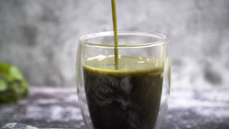 Close-Up-of-Pouring-green-detox-smoothie-in-glas