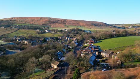 Aerial-footage-of-the-small-village-of-Denshaw,-and-the-church-and-graveyard,-a-typical-rural-village-in-the-heart-of-the-Pennines