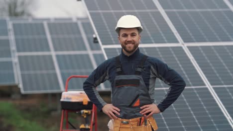 Close-up-portrait-of-a-male-worker-in-a-uniform-with-tools-on-the-background-of-a-solar-power-plant