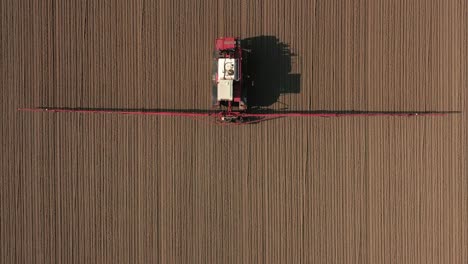 Agricultural-sprayer-symmetrical-topshot-farmer