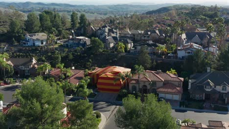 Aerial-approach-of-a-large-house-that-has-been-tented-for-termites-in-an-affluent-neighborhood-in-Southern-California