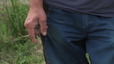 Closeup-Of-Hands-And-Pants-Of-An-Agricultural-Farmer-During-Harvest-Season